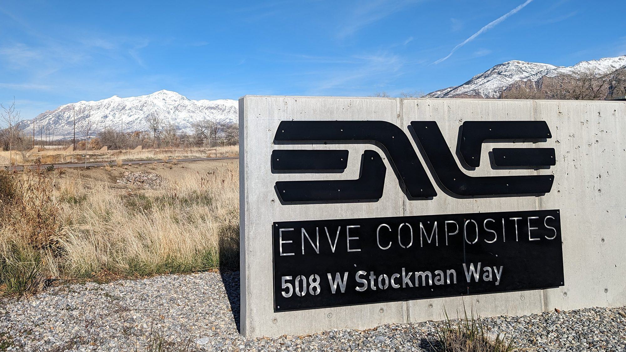 The ENVE Composites sign in front of snow-capped mountains